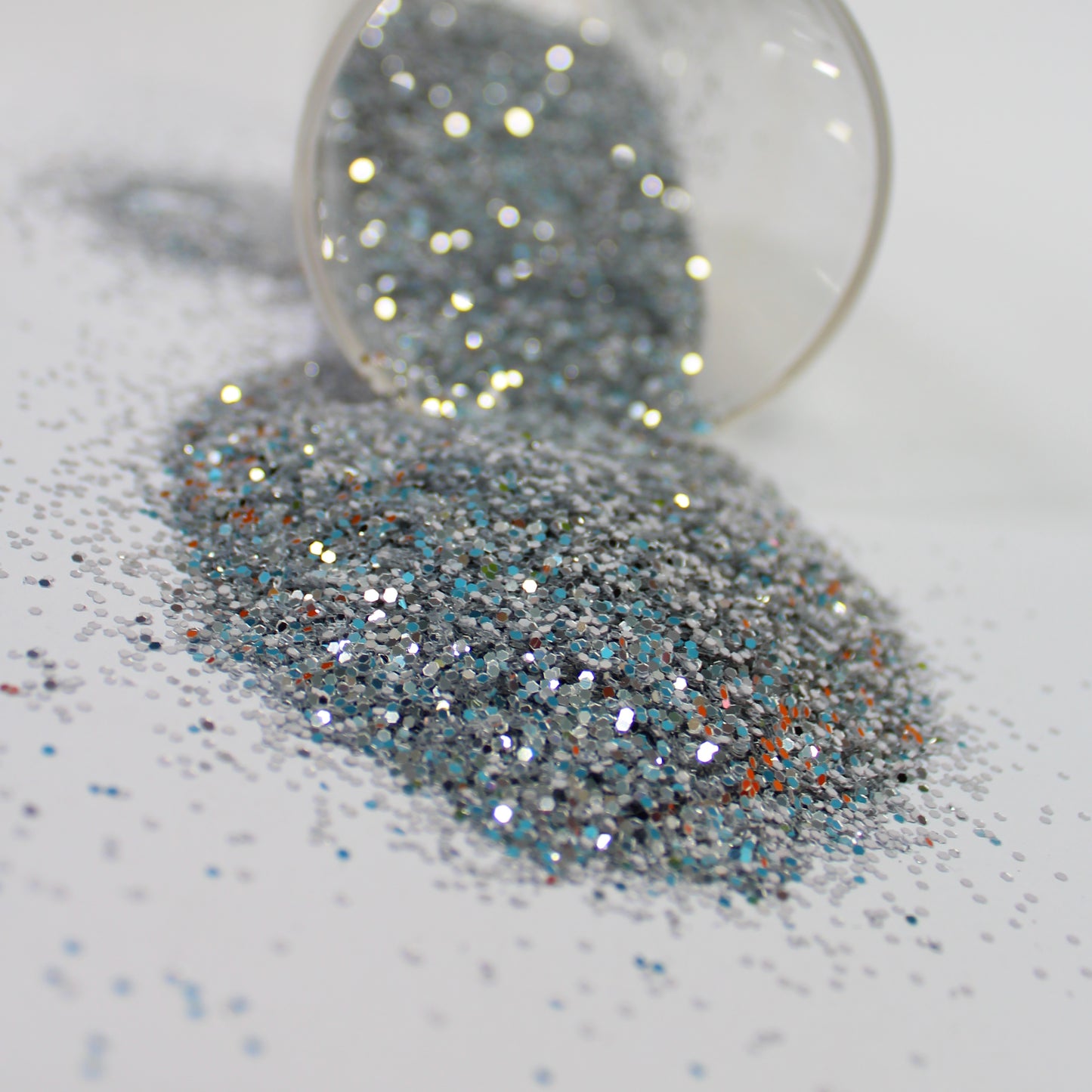 silver Glitter in a clear container on a white background
