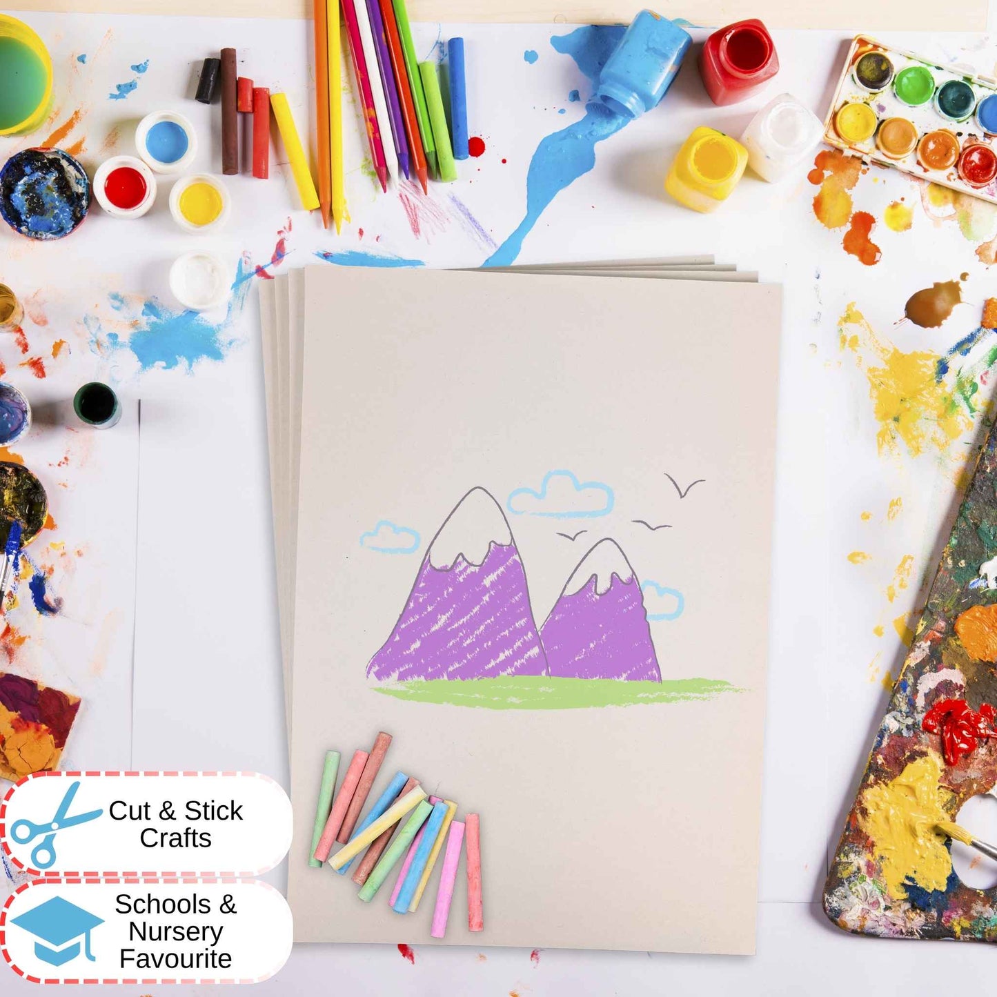 White Sugar Paper with mountain drawing surrounded by art supplies on a white background