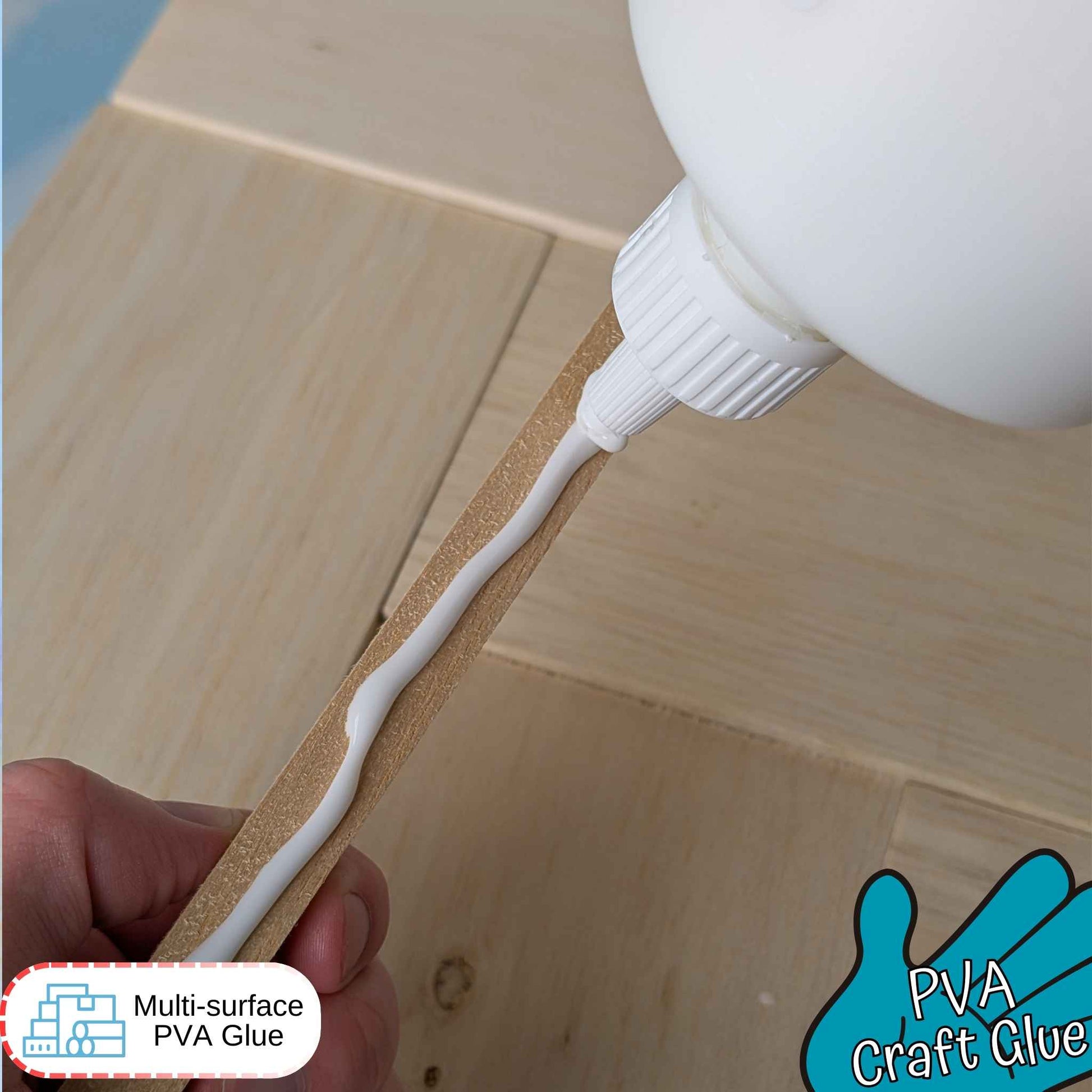 PVA craft glue being applied to a wooden surface with a glue bottle and hand holding the glue.
