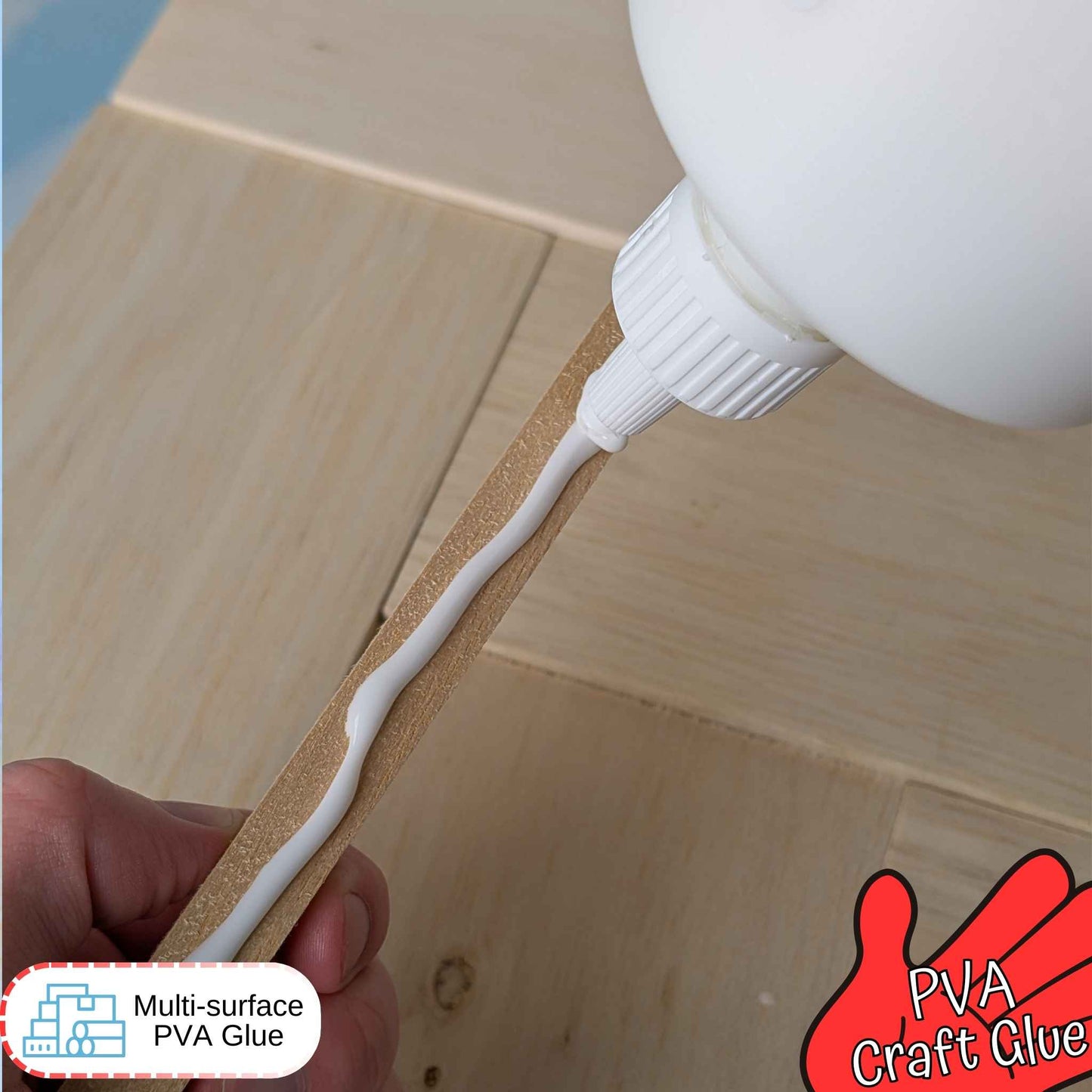 PVA craft glue being applied to a wooden surface with a glue bottle and hand holding the glue.
