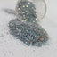 silver Glitter in a clear container on a white background