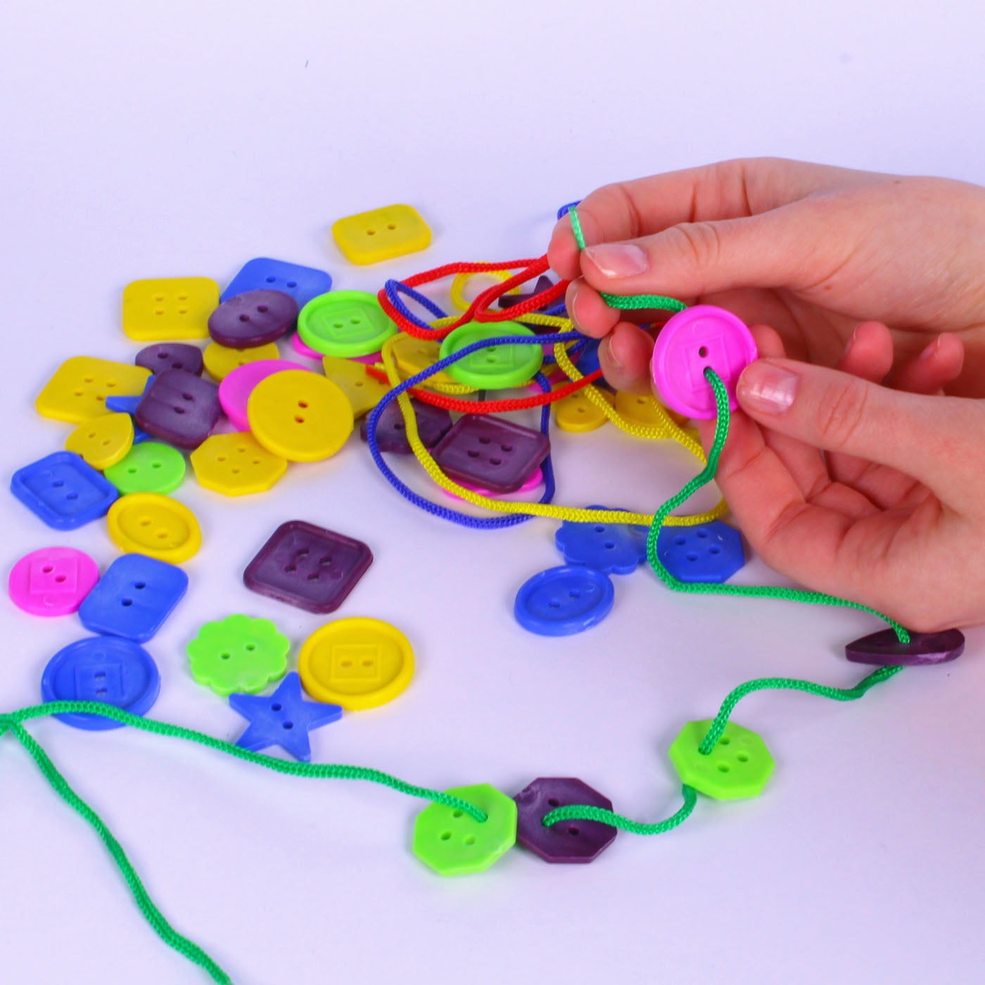 Barrel of Threading Buttons with laces assorted colours